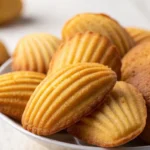 Madeline cookies recipe using cream - Madeline cookies served on a rustic wooden tray