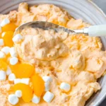 Creamy Orange Creamsicle Salad with mandarin oranges, whipped topping, and marshmallows.